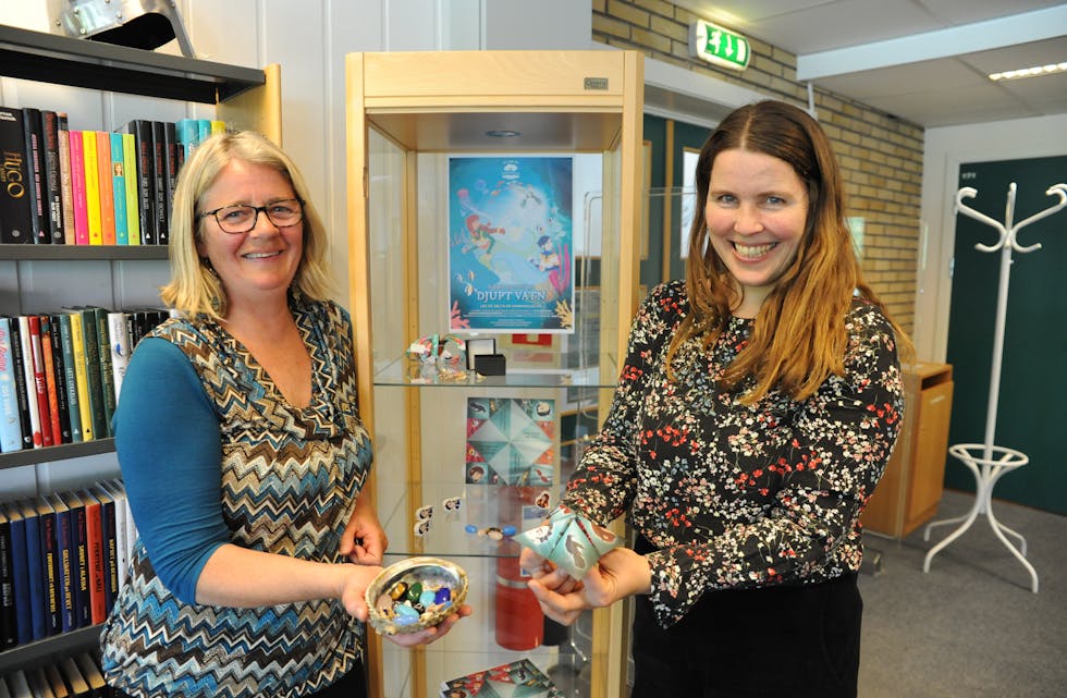 SOMMARLES: Sigrid Bjerke (f.v.) og Lynn Anita Tandberg ved Midt-Telemark bibliotek viser fram premiar til årets Sommarles. Premiane er utstilte i glasmonter på biblioteket.